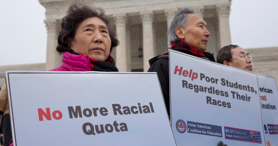 A picture of people gathering around protesting against Asian American racial quotas