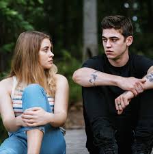 Still image of the main couple, Hardin and Tessa, just sitting on a dock.