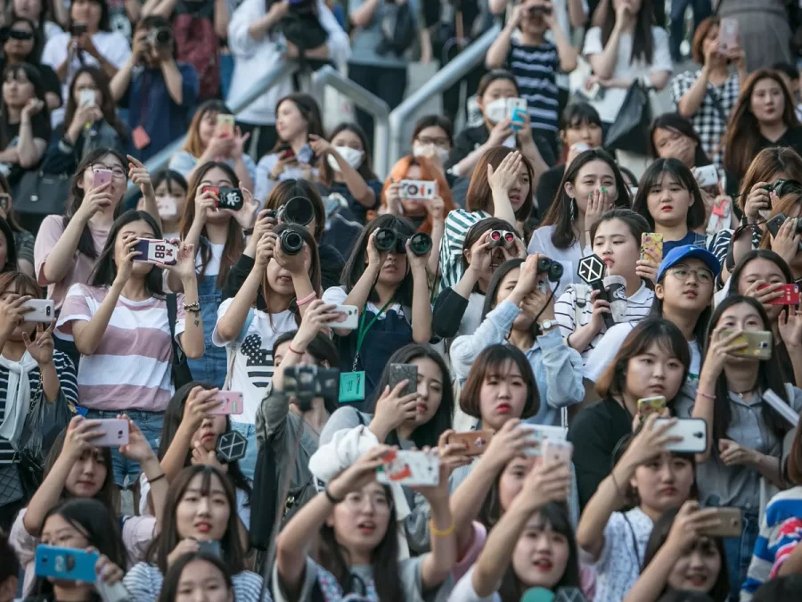 South Korean K-pop fans wait for their idols at a parking lot
