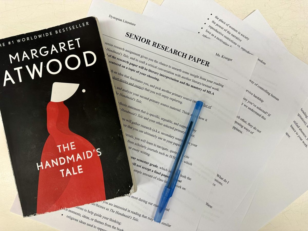 Photo+of+The+Handmaid%E2%80%99s+Tale+by+Margaret+Atwood+and+pages+of+the+guidelines+for+the+senior+research+paper+assignment
