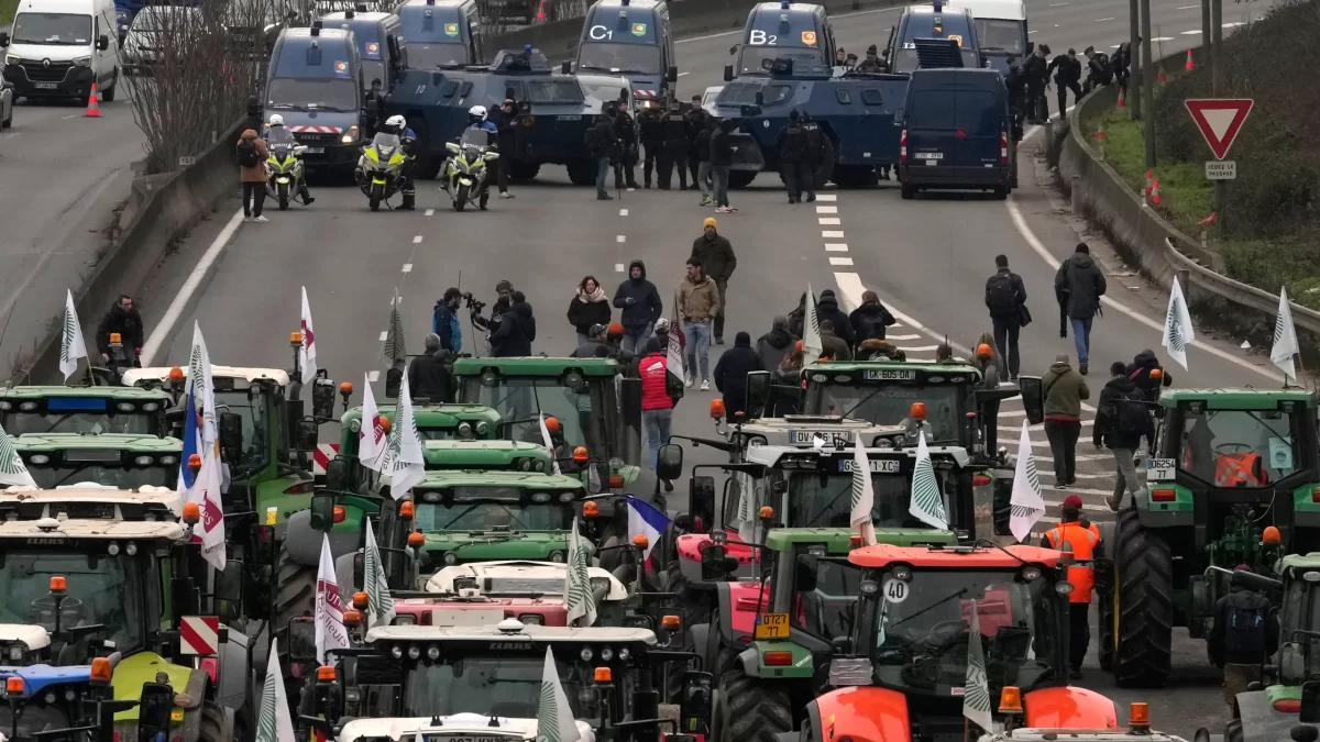 The farmers’ tractors in a standoff against military vehicles on a highway south of Paris.