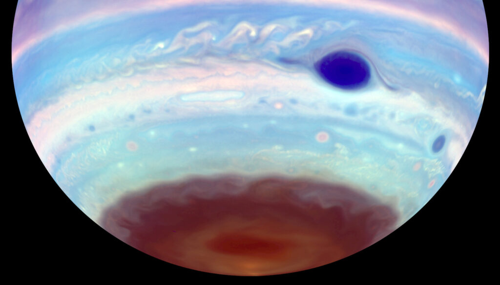 This artificially colored image of Jupiter, captured in ultraviolet light, reveals the Great Red Spot appearing blue. Another oval-shaped feature is visible within the brown haze near Jupiter's south pole. This oval, a region of dense haze, may result from mixing caused by a vortex in the planet's upper ionosphere.

Credit: Troy Tsubota and Michael Wong, UC Berkeley