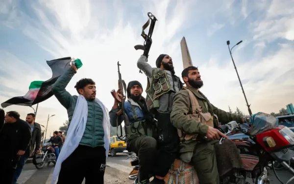 "Opposition fighters shoot in the air as they celebrate in Damascus. (AP Pic)" 