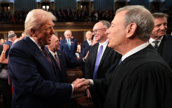 Donald Trump greets Chief Justice John Roberts at the US Capitol during the President's address at the joint session with Congress. 