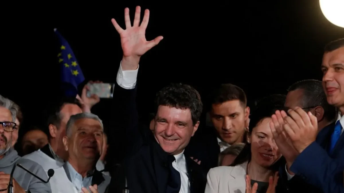 Romanian President-Elect Nicusor Dan celebrating in front of a crowd after an upset victory in the 2025 Romanian presidential election