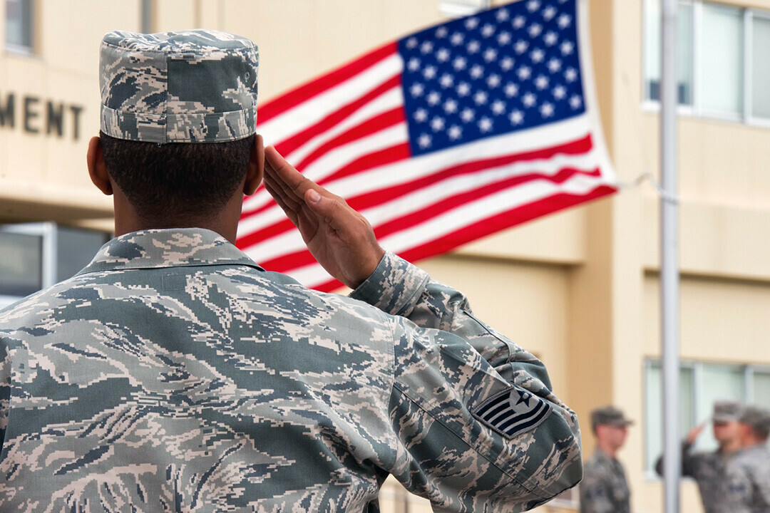 U.S. Air Force Tech. Sgt. Joe Gamble, foreground, a professional military education instructor with the 374th Force Support Squadron Airman Leadership School, salutes as a U.S. flag is lowered during a retreat ceremony at Yokota Air Base, Japan, Sept. 26, 2013.

More:

 Retreat was performed to signal the end of the official duty day and pay respect to the flag. (DoD photo by Yasuo Osakabe, U.S. Air Force/Released). Original public domain image from Flickr